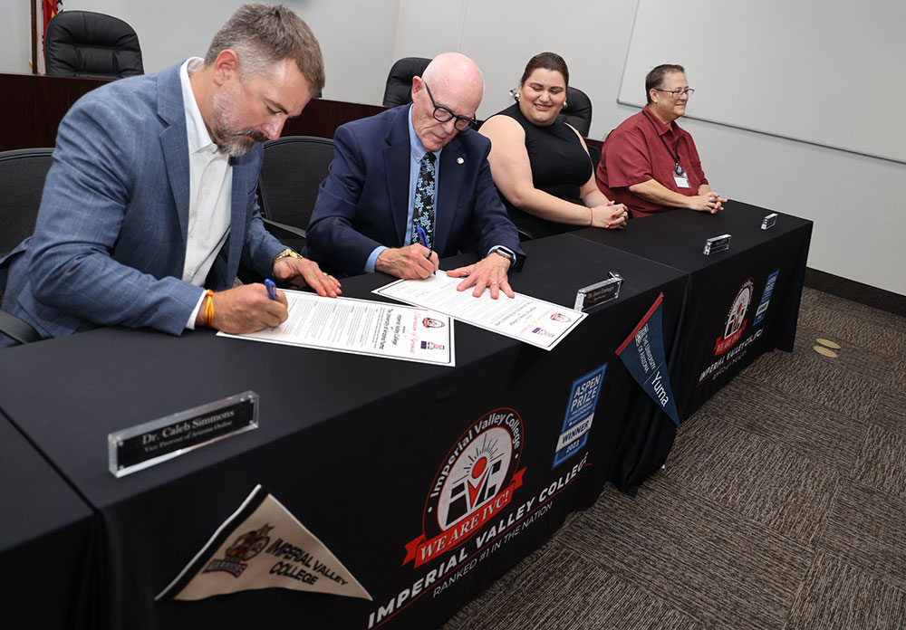 From left, University of Arizona Vice Provost Dr. Caleb Simmons and IVC Interim Superintendent/President Dr. James M. Limbaugh sign the MOU as IVC vice presidents look on. PHOTO COURTESY OF IMPERIAL VALLEY COLLEGE