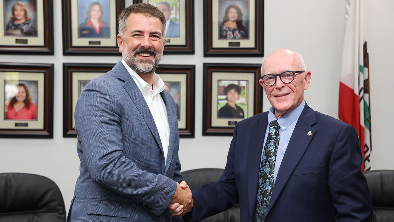 From left, University of Arizona Vice Provost Dr. Caleb Simmons shakes hands with IVC Interim Superintendent/President Dr. James M. Limbaugh following the official MOU signing. PHOTO COURTESY OF IMPERIAL VALLEY COLLEGE